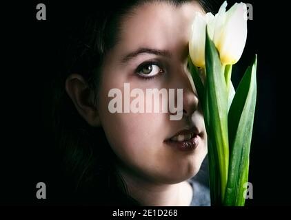 teenager with tulip in hand III Stock Photo