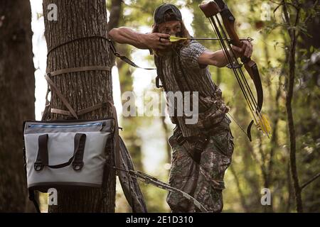 Deer hunter with bow and arrow, Bear Creek Reserve, Georgia, USA Stock Photo