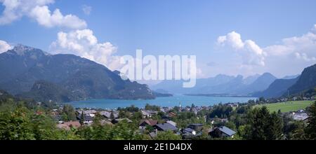 Panorama Wolfgangsee the largest lake in Austria along with the towering mountains around it. Fancy view from the town of Sankt Gilgen to the whole bo Stock Photo