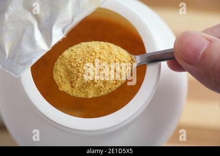 Soy lecithin in a teaspoon. Close up. Stock Photo