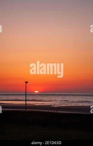 Rhyl beach at sunset on the North Wales coast Stock Photo