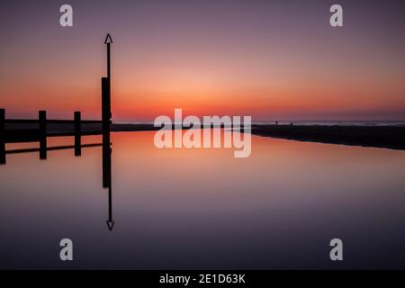 Rhyl beach at sunset on the North Wales coast Stock Photo