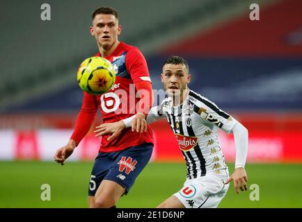 Soccer Football - Ligue 1 - Lille v Angers - Stade Pierre-Mauroy, Lille, France - January 6, 2021 Lille's Sven Botman in action with Angers' Mathias Pereira Lage REUTERS/Pascal Rossignol