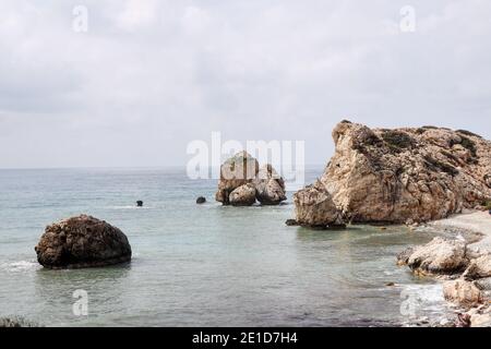 Beautiful and famous destination in South Cyprus, Petra tou Romiou nearby Kouklia. Aphrodite rock with cloudy sky and mediterranean sea which plays sh Stock Photo