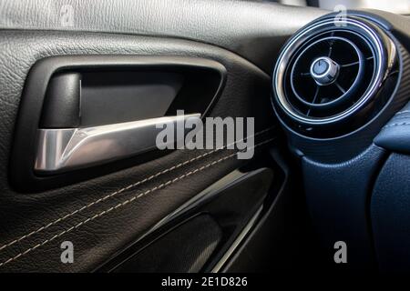 Car door handle with Air conditioning vent inside the modern car. Stock Photo