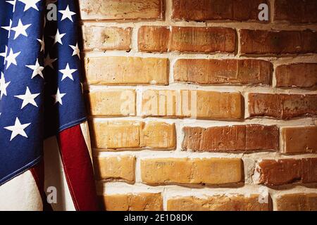 USA flag near a brick wall. Texture background image Stock Photo