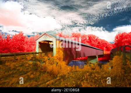 The newly renovated Shieldstown Covered Bridge near Shieldstown, IN shot in false color infrared light.  High clouds, vibrant blues, and deep colors. Stock Photo