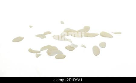 Pile of peeled flaked almonds isolated on white. Blanched almonds flakes on white. Stock Photo