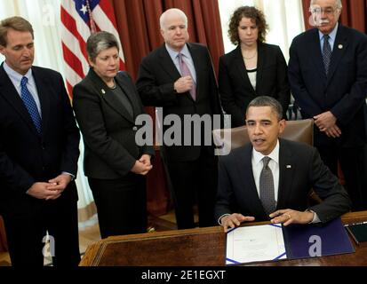From left, Rep. Jeff Flake (R-AZ), Secretary of Homeland Security Janet A. Napolitano, Senator John McCain (R-AZ), Pia Carusone, chief of staff for Rep. Gabrielle Giffords (D-AZ), Rep. Ed Pastor (D-AZ), and Rep. Trent Franks (R-AZ) listen as President Barack Obama speaks before signing the John M. Roll United States Courthouse Bill in the Oval Office of the White House in Washington, DC on February 17, 2011. President Obama signed the bill which names a federal courthouse in Yuma, Arizona after Judge John Roll who was a federal judge killed along with 18 others by Jared Loughner during an assa Stock Photo