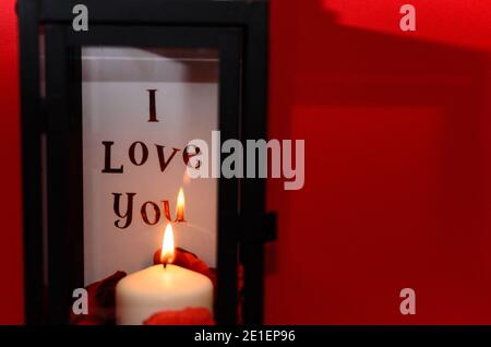 Love message inside lantern with candle and copy space on side Stock Photo