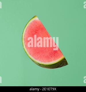 fresh raw watermelon piece isolated on green background Stock Photo