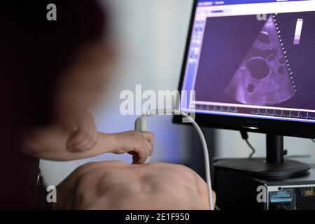 a doctor performs ultrasound on a teaching dummy Stock Photo