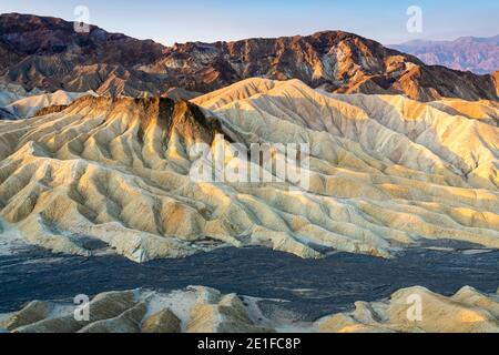 Scenic view of natural rock formations at Zabriskie Point after sunrise, Death Valley National Park, California, USA Stock Photo