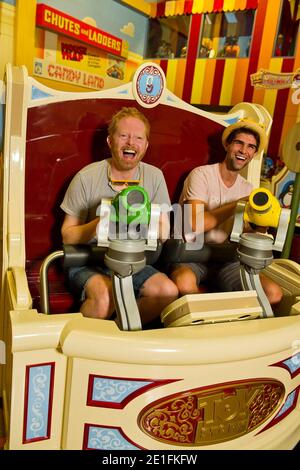 Actor Jesse Tyler Ferguson (left) joins Justin Mikita (right) on March 24, 2011 for a ride aboard 'Toy Story Mania!' at Disney's Hollywood Studios in Lake Buena Vista, Florida. Ferguson portrays 'Mitchell' on the ABC-TV series 'Modern Family.' Ferguson and Mikita are on vacation at the Walt Disney World Resort.on March 24, 2011. Photo by Matt Stroshane/Disney Handout/ABACAUSA.COM Stock Photo