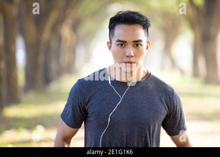 Handsome asian young  man exercising in the park at morning Stock Photo