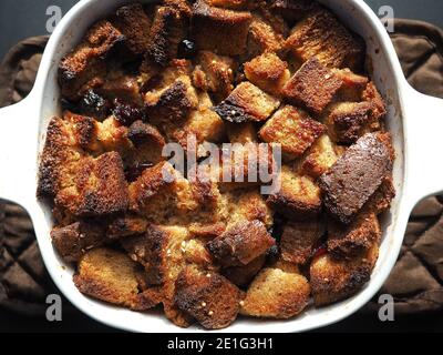 flat lay of bread pudding with raisins in white baking dish Stock Photo
