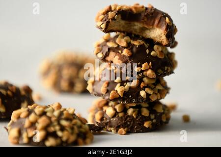 stack of Chocolate cookie with peanut butter center sprinkled with bits of peanut Stock Photo