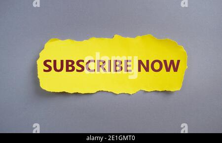SUBSCRIBE NOW text written on yellow torn paper.Conceptual hand writing showing Subscribe Now. Business photo text to pay money to an organization in Stock Photo