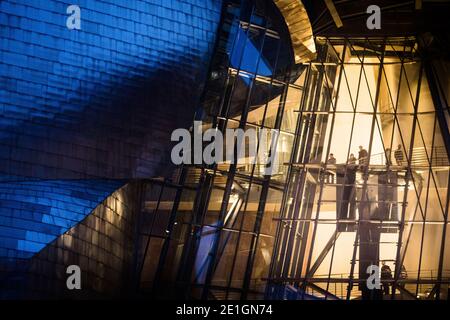 Exterior view of the curved titanium and glass facade of The Guggenheim Museum in Bilbao, Basque Country, Spain at night. Stock Photo