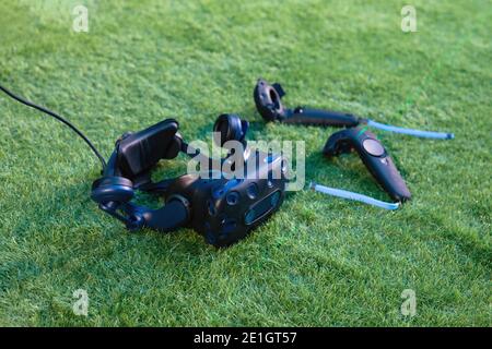 Premium VR headset with steamVR kit. VR goggles and VR controllers on green background. Stock Photo