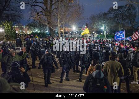 January 6th 2021.Riot Police pushing Pro Trump Supporters out US Capitol grounds to 1st street NW. Washington DC. USA. Stock Photo