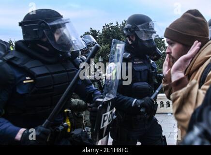 Washington Dc, United States. 06th Jan, 2021. Police clash with a pro-Trump supporter outside the United States Capitol during the Pro-Trump rally.Pro-trump supporters stormed the United States Capitol after the loss of US President Donald Trump at the election. Credit: SOPA Images Limited/Alamy Live News Stock Photo