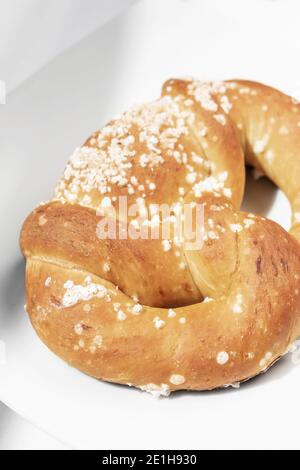 vegan dairy-free organic german traditional pretzel bread on white table Stock Photo