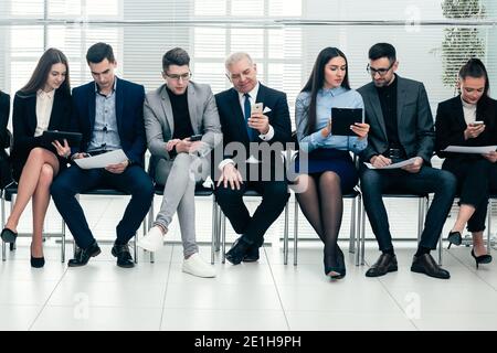 group of business people use their gadgets before starting a business meeting Stock Photo