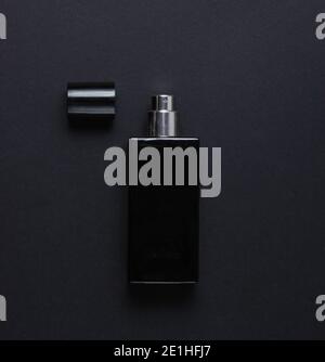 Bottle of male perfume on black background. Top view Stock Photo