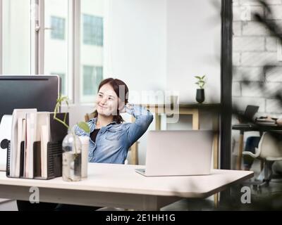 young asian business woman working in office using desktop computer Stock Photo