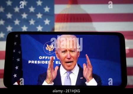 Kiev, Kyiv, Ukraine. 7th Jan, 2021. In this photo illustration the US President-elect Joe Biden addresses Trump Supporters while they continue with protests in and near the U.S. Capitol in Washington during the U.S. Congress session to certify the 2020 Presidential election results on a fragment of a youtube video displayed on a smartphone screen. Credit: Pavlo Gonchar/SOPA Images/ZUMA Wire/Alamy Live News Stock Photo