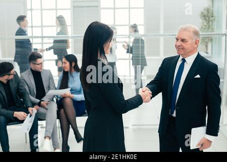 boss and the assistant discuss a business document. Stock Photo