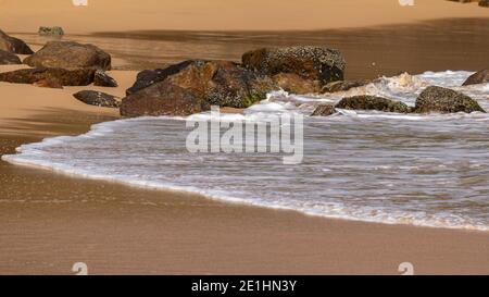 waves on the beach, washing the golden sand in the evening, empty beaches post coronavirus. Stock Photo