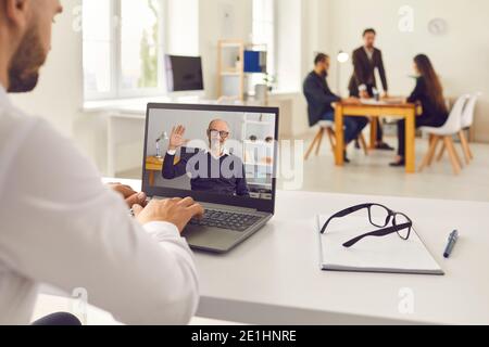 Man having online video meeting with senior boss or company client or attending educational webinar Stock Photo