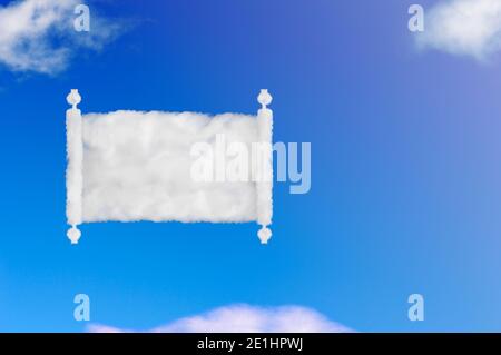 opened scroll of papyrus shape of cloud on blue sky. Stock Photo