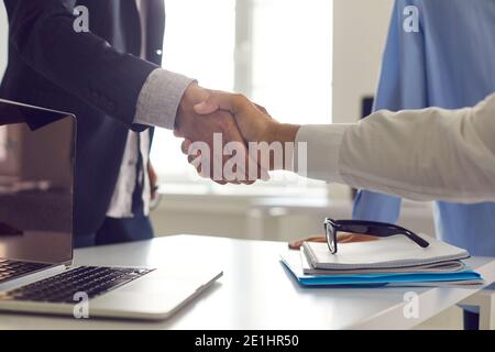 Businessman shaking hands with his client, confirming their business cooperation Stock Photo