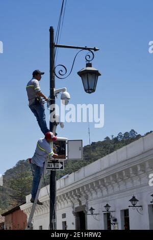 Two electricians on historic lantern (Antigua, Guatemala, Central America) Stock Photo