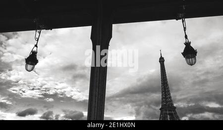 Eiffel tower seen through frame of  Bir-Hakeim bridge. Paris, France. Black and white photo. Stock Photo