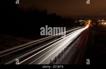 light from cars on a hill down to the Ersboda shopping area Stock Photo