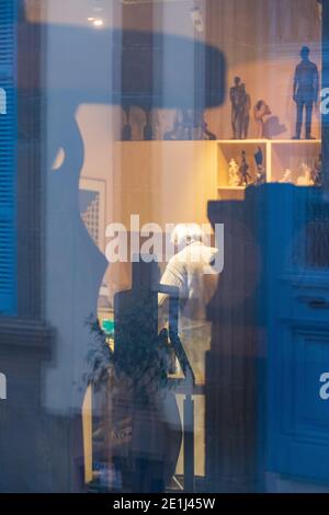 Nicosia, Cyprus - December 9, 2020: View form the outside of a window of an artist's workshop in old Nicosia with the artist in the background. Stock Photo