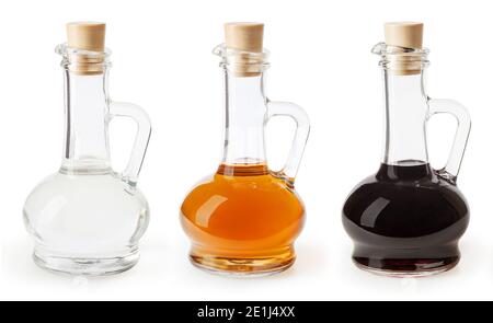 White, apple cider and balsamic vinegar in glass bottles isolated on white background Stock Photo