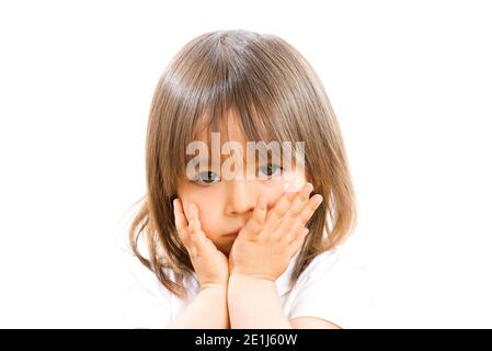 Two years old girl with hands in front the face on white background. Stock Photo