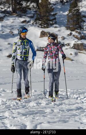Young woman practicing ski touring during a snowfall in the woods Stock ...