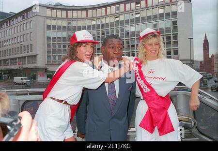 Frank Bruno opens a new Ladbrokes in Birmingham city centre in July 1990 with the company of two promotional girls to publicise the event. Stock Photo