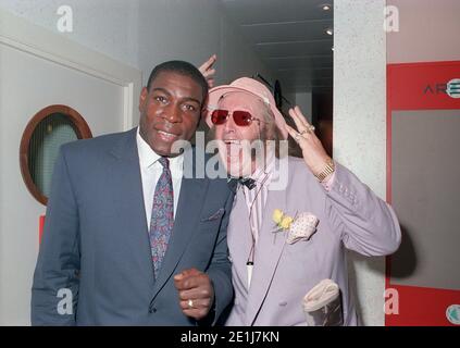 Frank Bruno opens a new Ladbrookes in Birmingham city centre in July 1990 supported by the ITV racing correspondent John McCririck Stock Photo