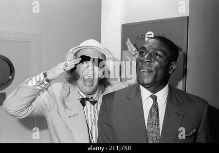 Frank Bruno opens a new Ladbrookes in Birmingham city centre in July 1990 supported by the ITV racing correspondent John McCririck Stock Photo