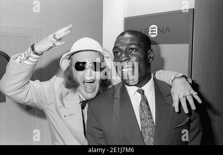 Frank Bruno opens a new Ladbrookes in Birmingham city centre in July 1990 supported by the ITV racing correspondent John McCririck Stock Photo