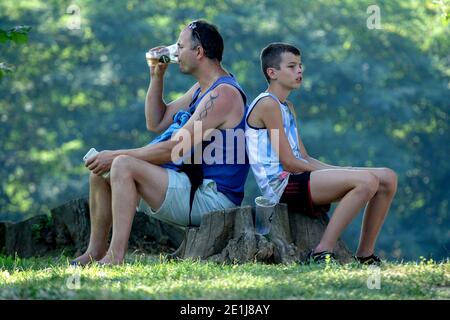 Father and son on trip Man drinking beer Stock Photo