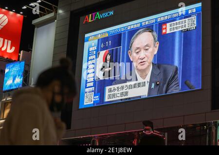 (210107) -- TOKYO, Jan. 7, 2021 (Xinhua) -- Japanese Prime Minister Yoshihide Suga speaking at a news conference is seen on a screen in Tokyo, Japan, on Jan. 7, 2021. The prime minister declared a state of emergency in the Tokyo metropolitan area including Tokyo, Saitama, Chiba and Kanagawa prefectures on Thursday, authorizing tougher measures to fight a resurgence in COVID-19 infections. The state of emergency will be effective from Friday to Feb. 7, with measures including urging people to stay at home and calling for restaurants and bars to stop serving alcohol by 7 p.m. and close by 8 p.m Stock Photo