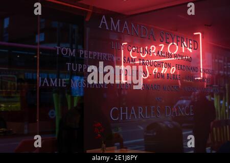 Arts & Culture concept - View of bright led signage through the window of Curzon, Soho, London, Britain, Dec 2020